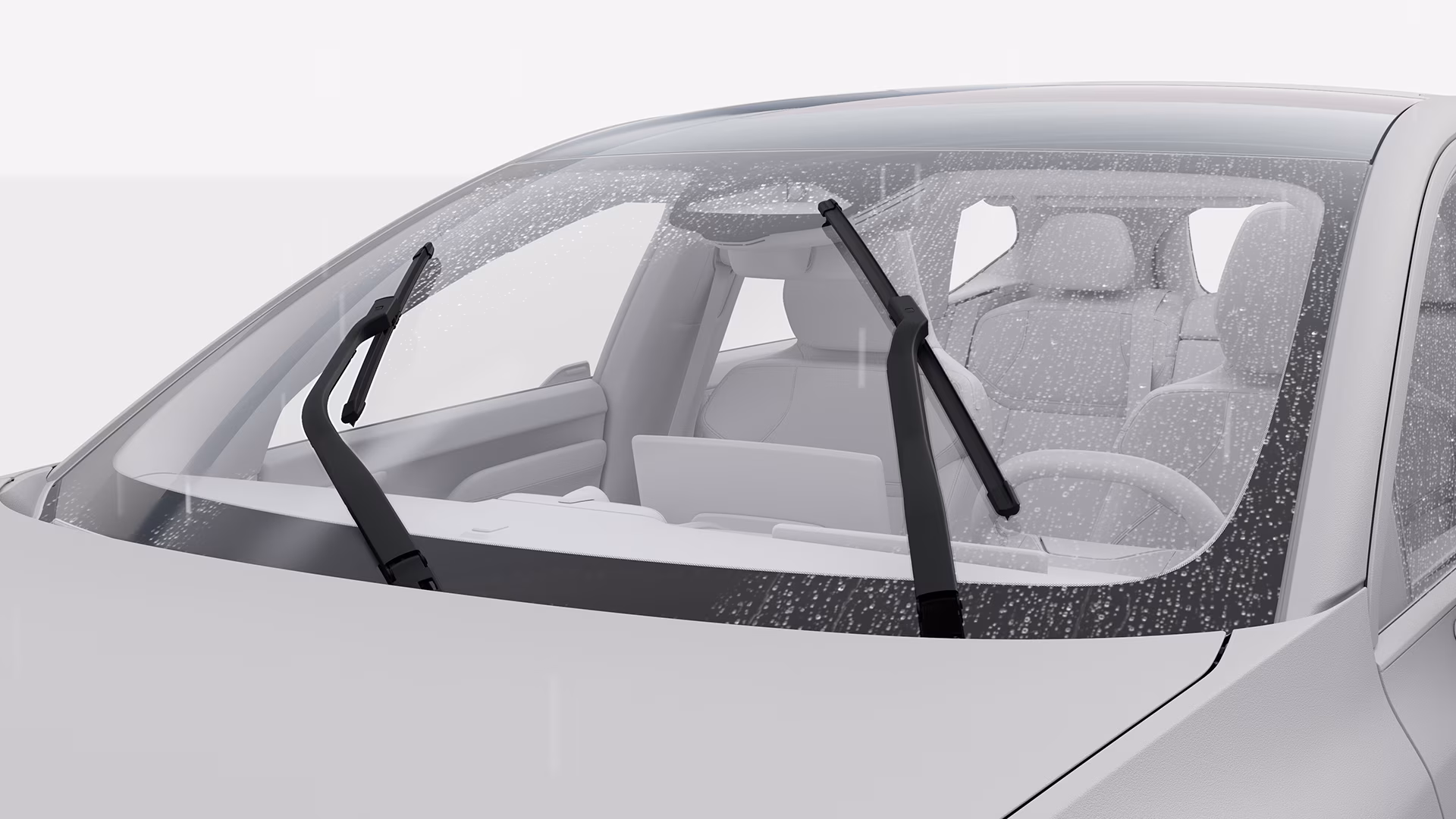 Крупный план лобового стекла автомобиля Volvo с дождем и активными стеклоочистителями, подчеркивающими функции обзора и безопасности.