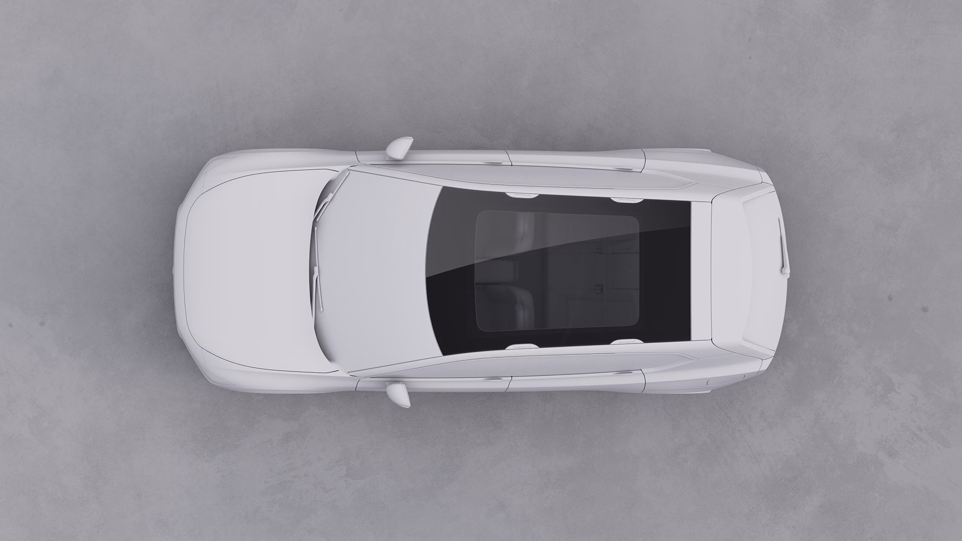 Вид сверху на автомобиль Volvo с панорамной стеклянной крышей на однотонном фоне.