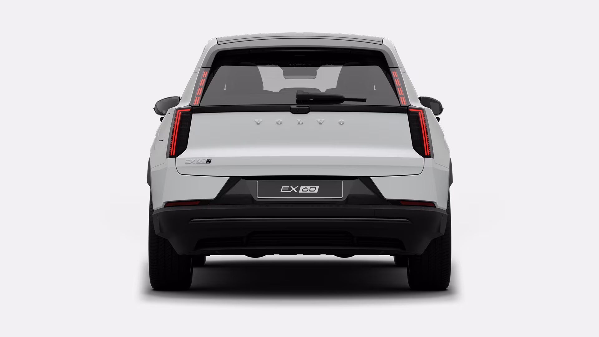 Вид сзади на белый Volvo EX60, с задней дверью, вертикальными задними фонарями и значком EX60.