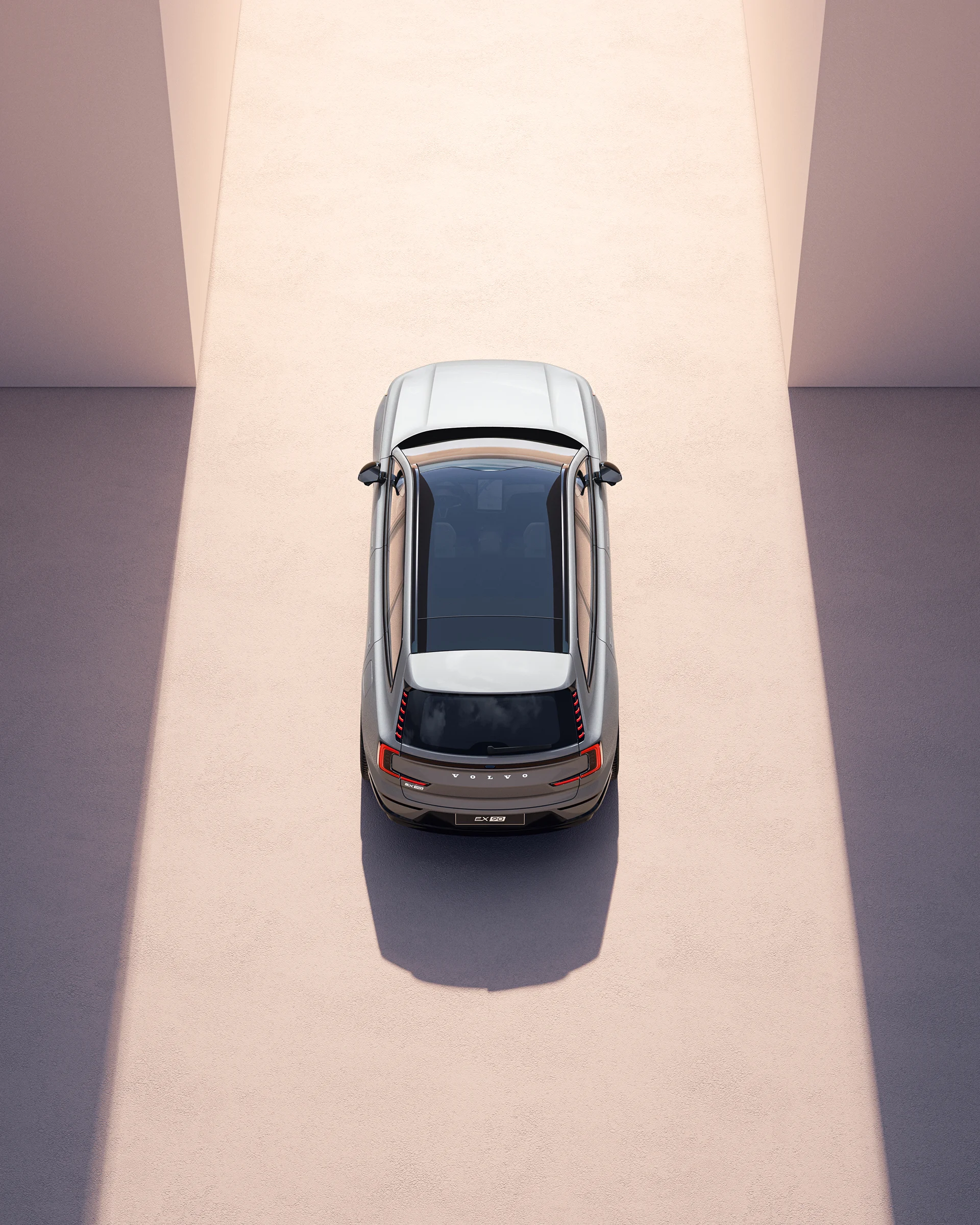 Вид сверху на Volvo EX90 с панорамной крышей и обтекаемой формой.