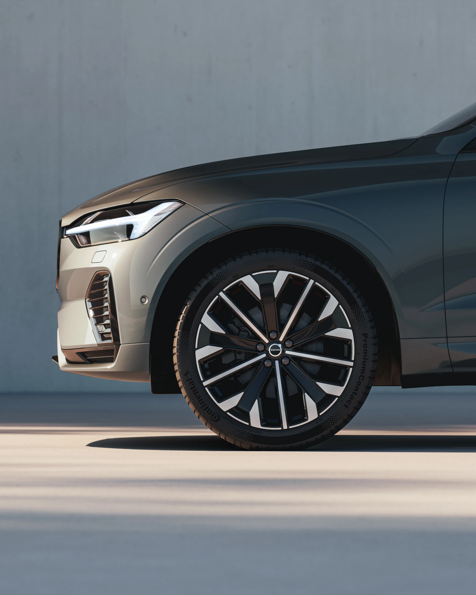 Крупный план переднего колеса мягкого гибридного внедорожника Volvo XC60 с черными аэродинамическими колесами.